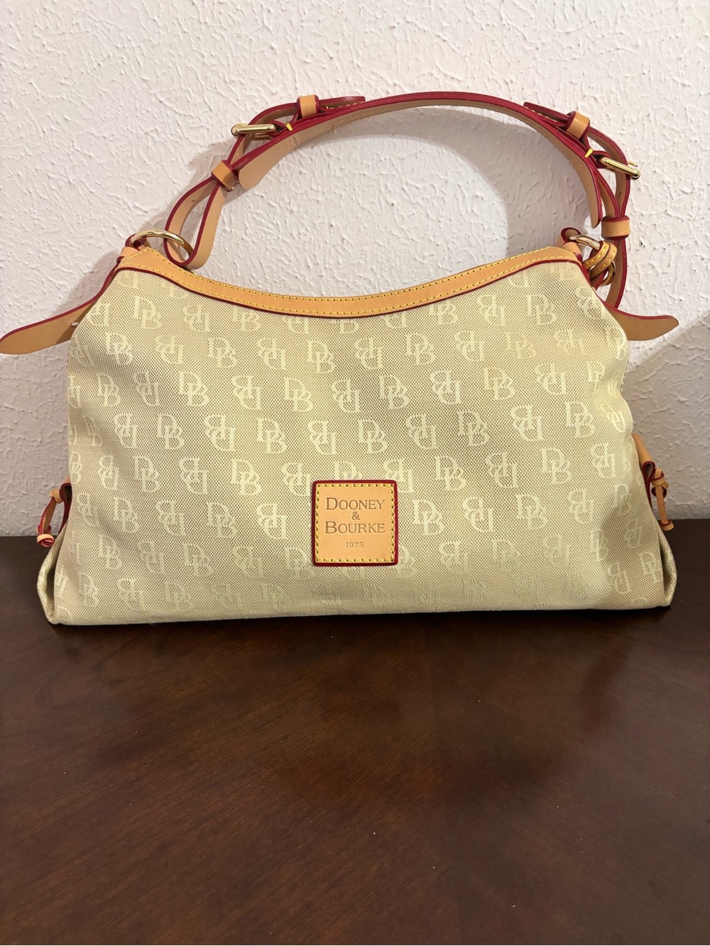Dooney & Bourke Cream Logo Shoulder Bag with Tan Trim and Red Accents